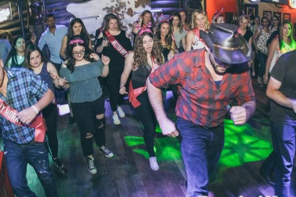 Mario teaching line dancing at a country bar; Urban Cowboy Line Dancing